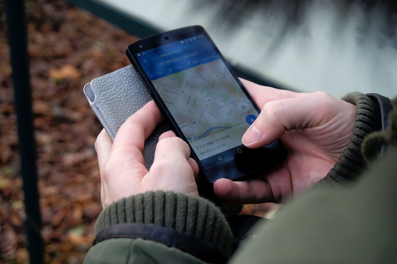 A lady planning her route on her mobile phone.