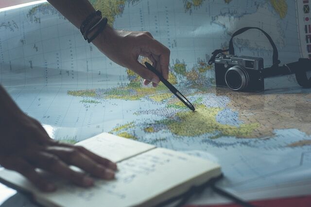 A tourist checking out multiple points on a map.